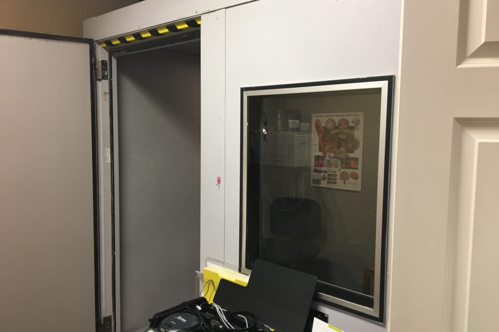outside hearing test booth with chair